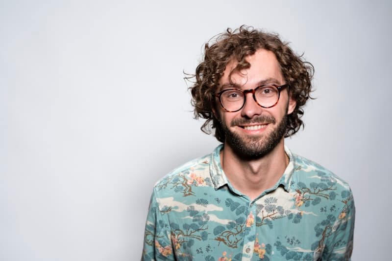 A man in glasses photographed outside the office