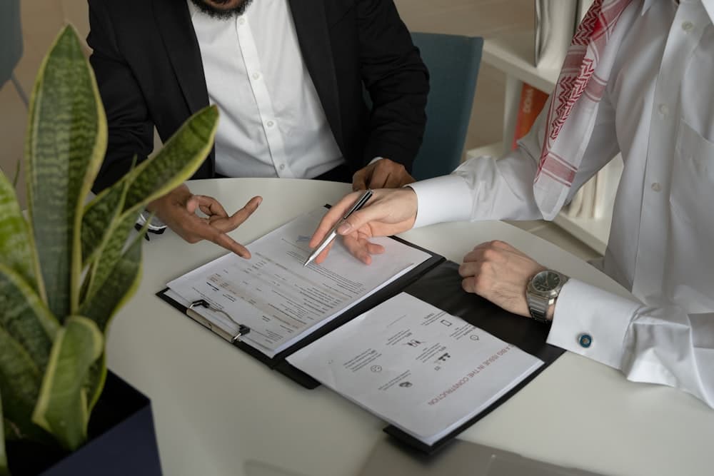 Two people working through papers together at a table