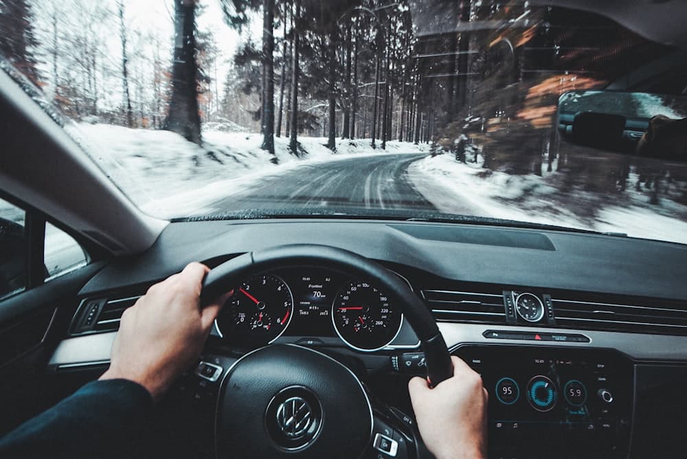 A driver's hands on the wheel during a test drive