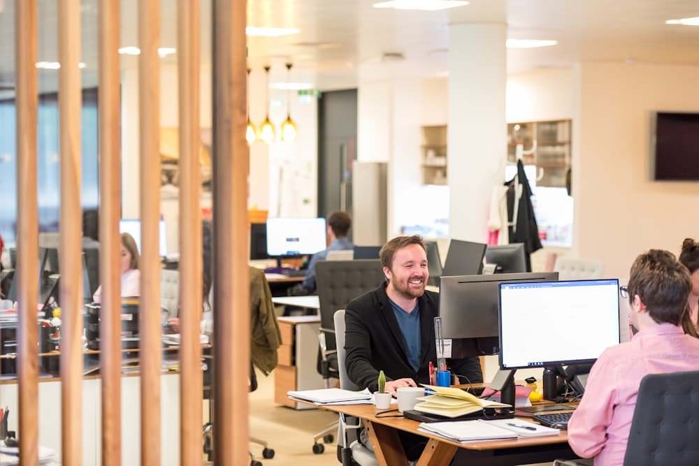 A man working at a desk in an open office