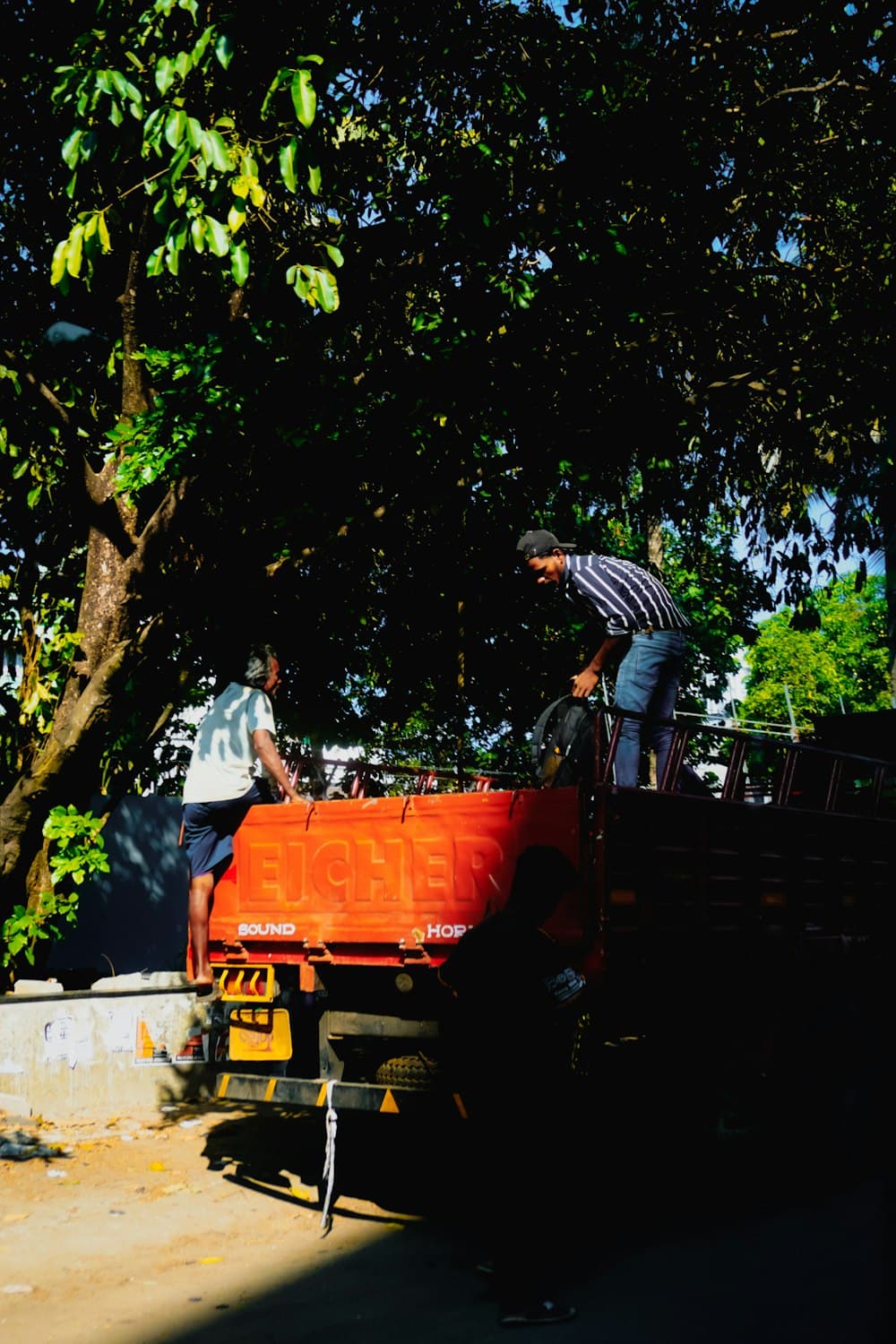 Two people loading equipment onto a truck