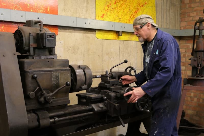 A man working at a machine in a factory