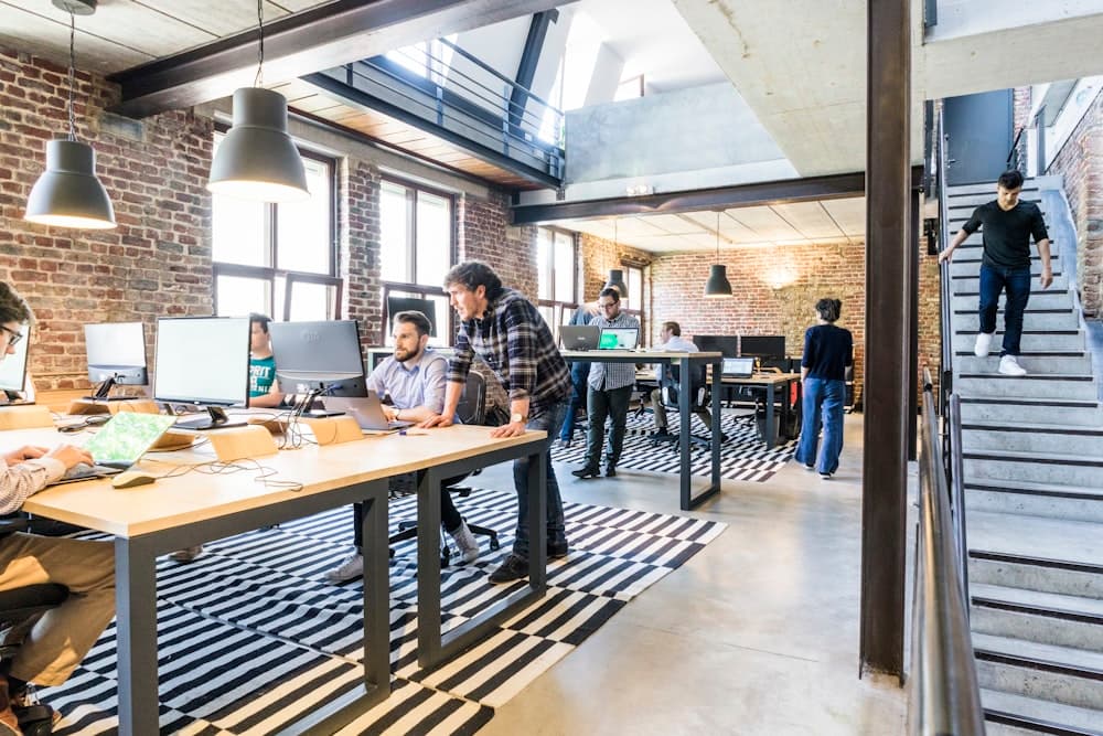 Two people working together at a computer in an office