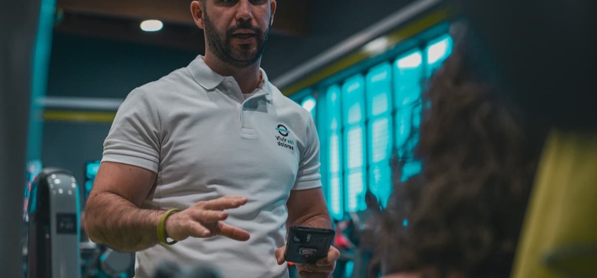 A trainer standing on the gym floor between sessions