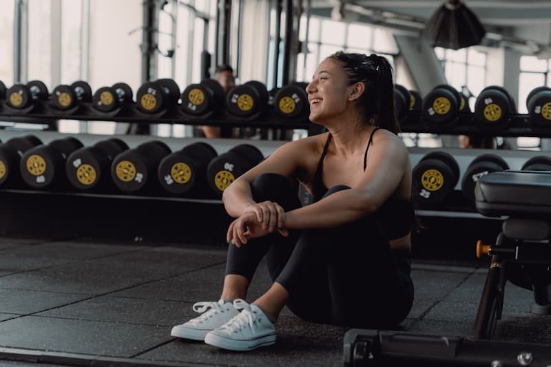 A coach sitting on the gym floor between sessions