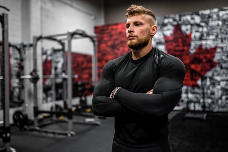 A studio owner in a black t-shirt on the gym floor