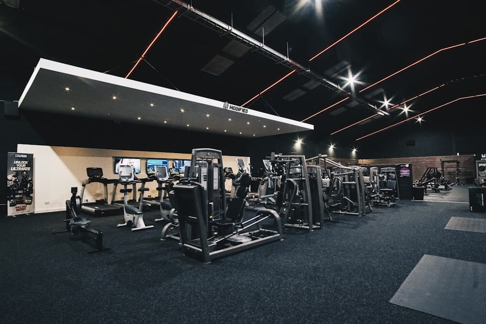 An empty gym floor with racked equipment before opening