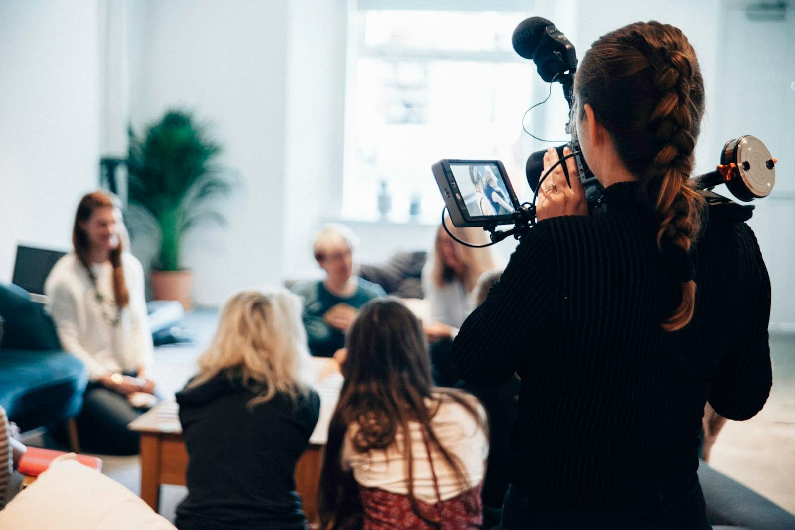 A photographer working a crowded event with her camera
