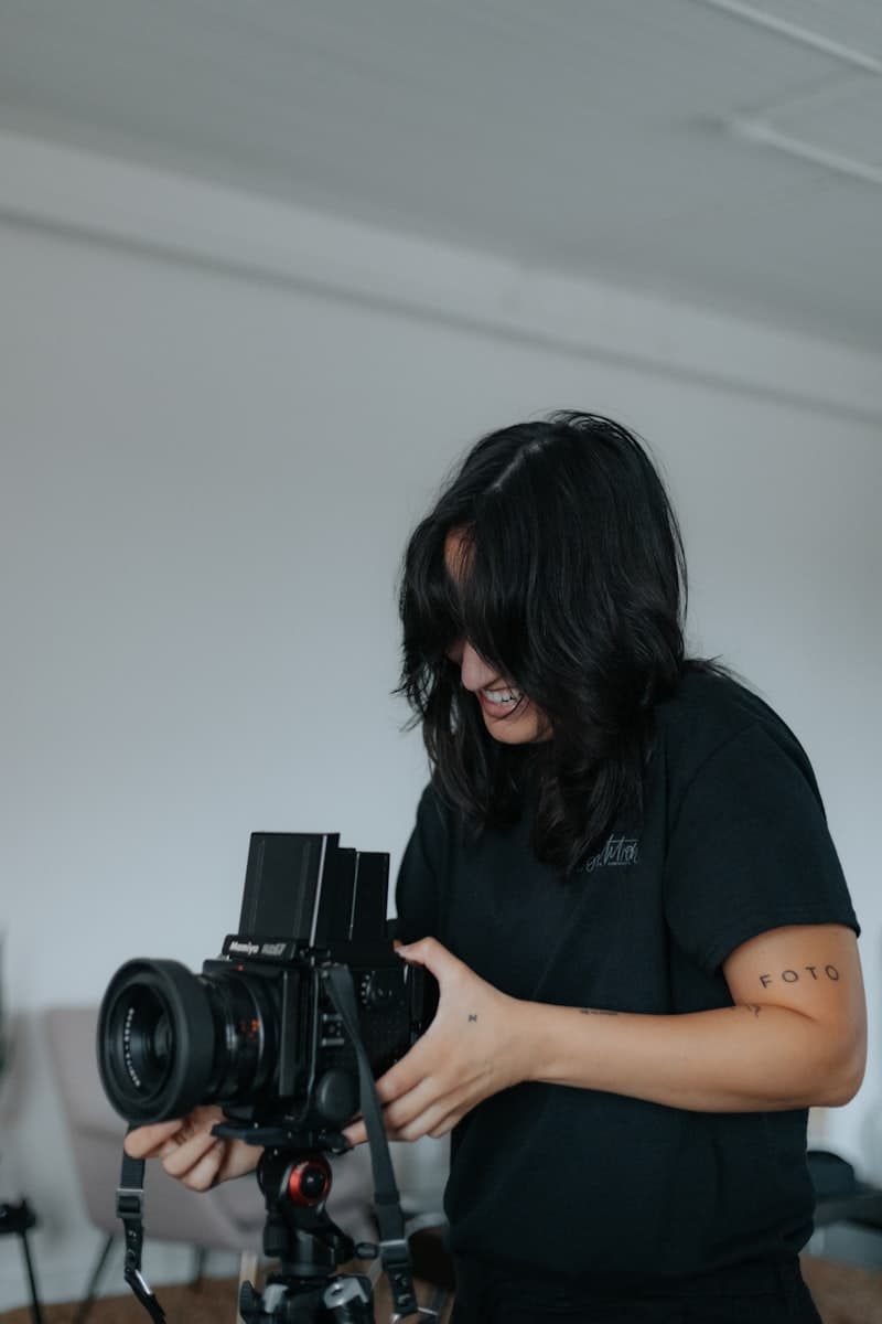 A woman holding a DSLR camera