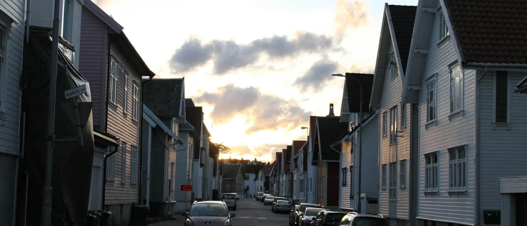 A residential street of wooden houses at dusk