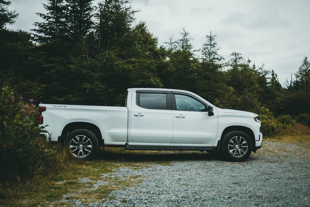 A white crew cab pickup on a gravel drive before the day starts