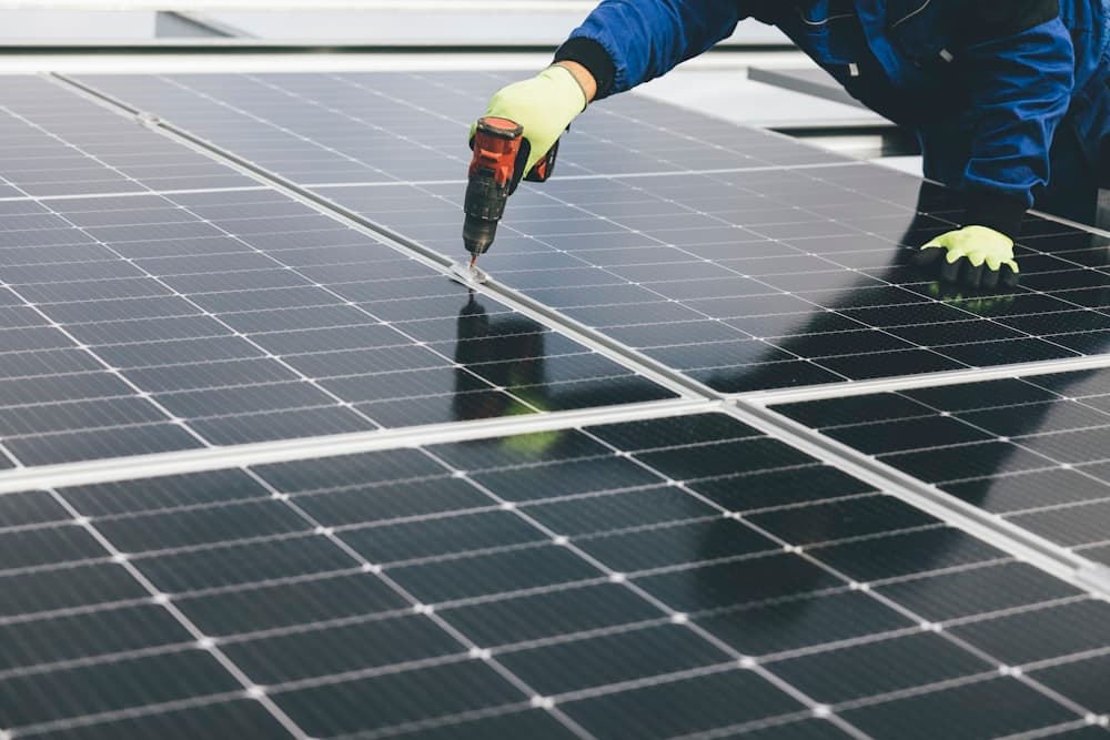 A person installing a solar panel on a roof