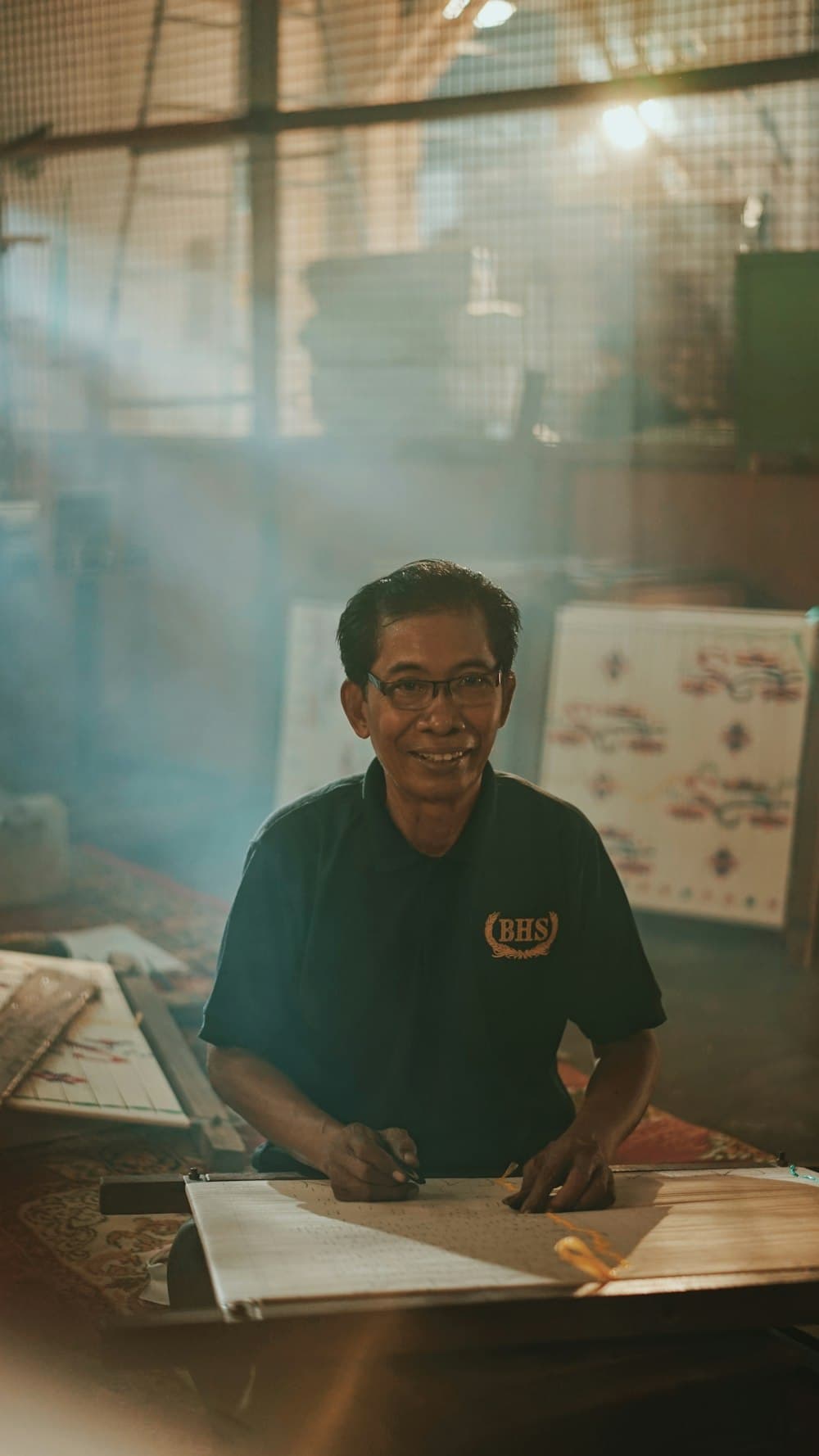 A man in glasses standing in an office