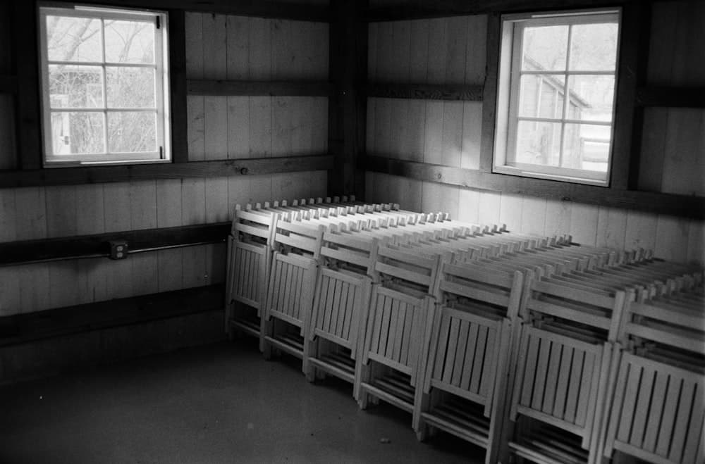 Stacked chairs waiting in a wooden hall before setup