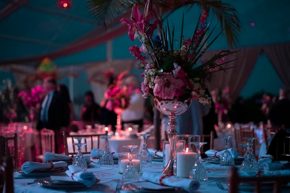 A reception table in low evening light with candles burning down