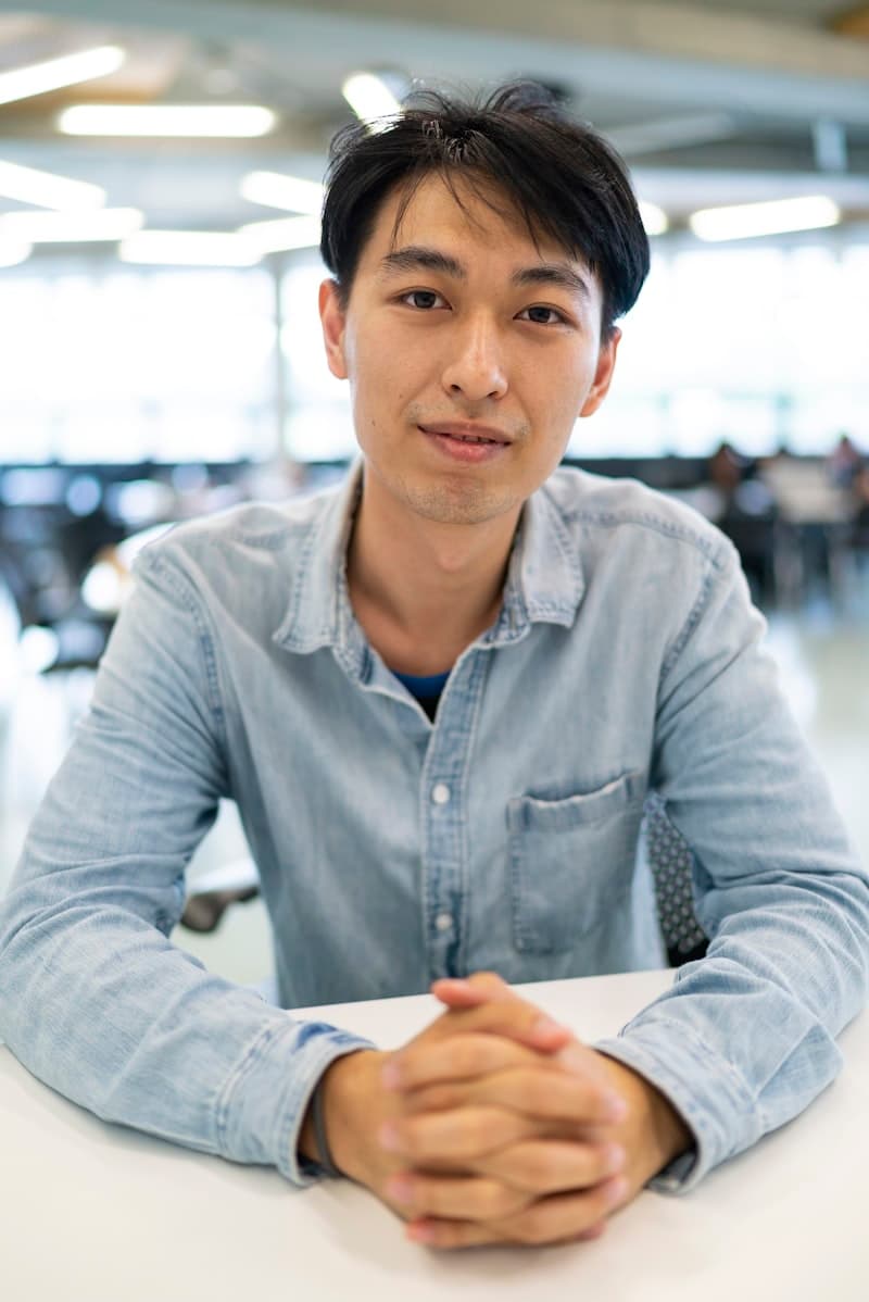 A woman in a blue shirt at her workspace