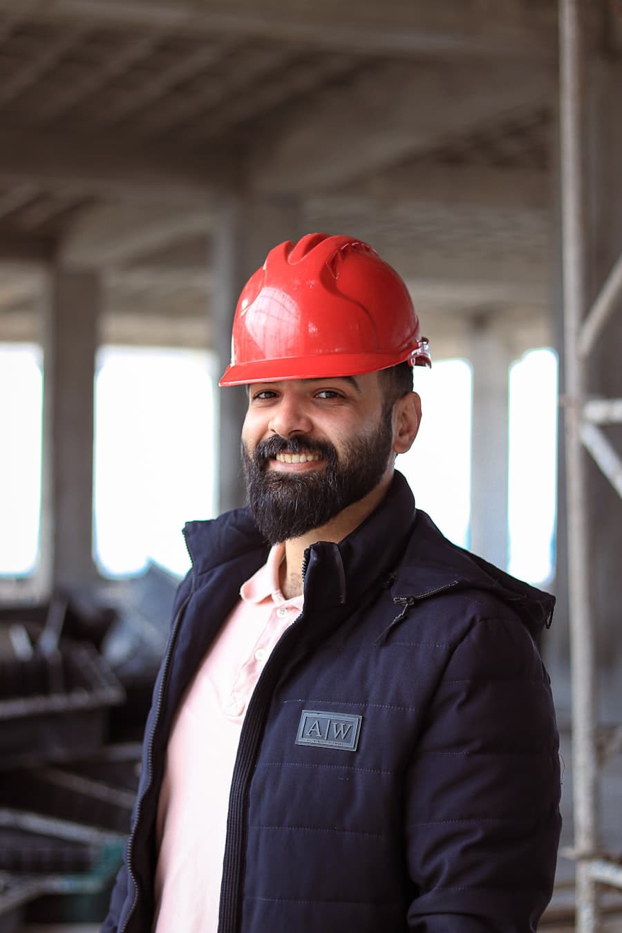 A man in a red hard hat on a concrete structure