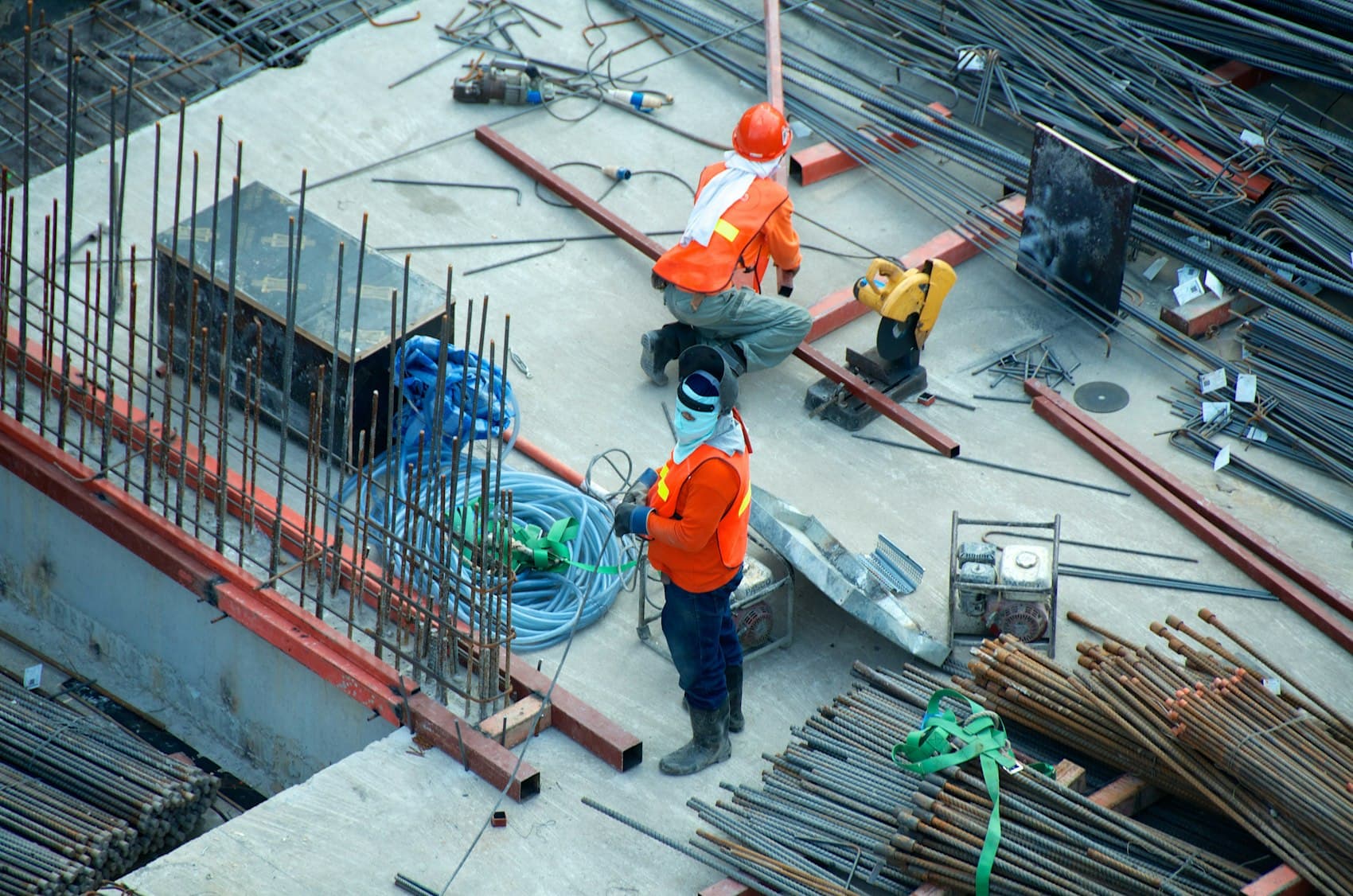 Workers placing rebar on a structural deck