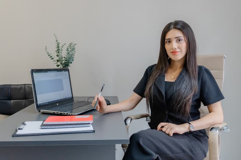 A woman at her desk with a laptop