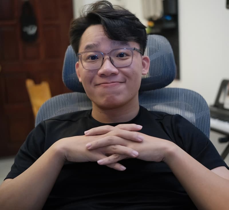 A young consultant in glasses seated in a chair