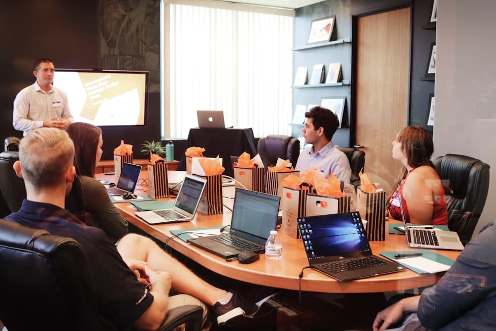 A consultant leading a workshop in front of a client team