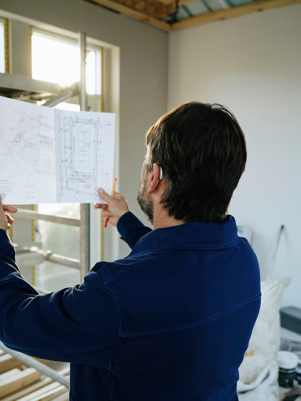 A man reviewing plans at a construction site