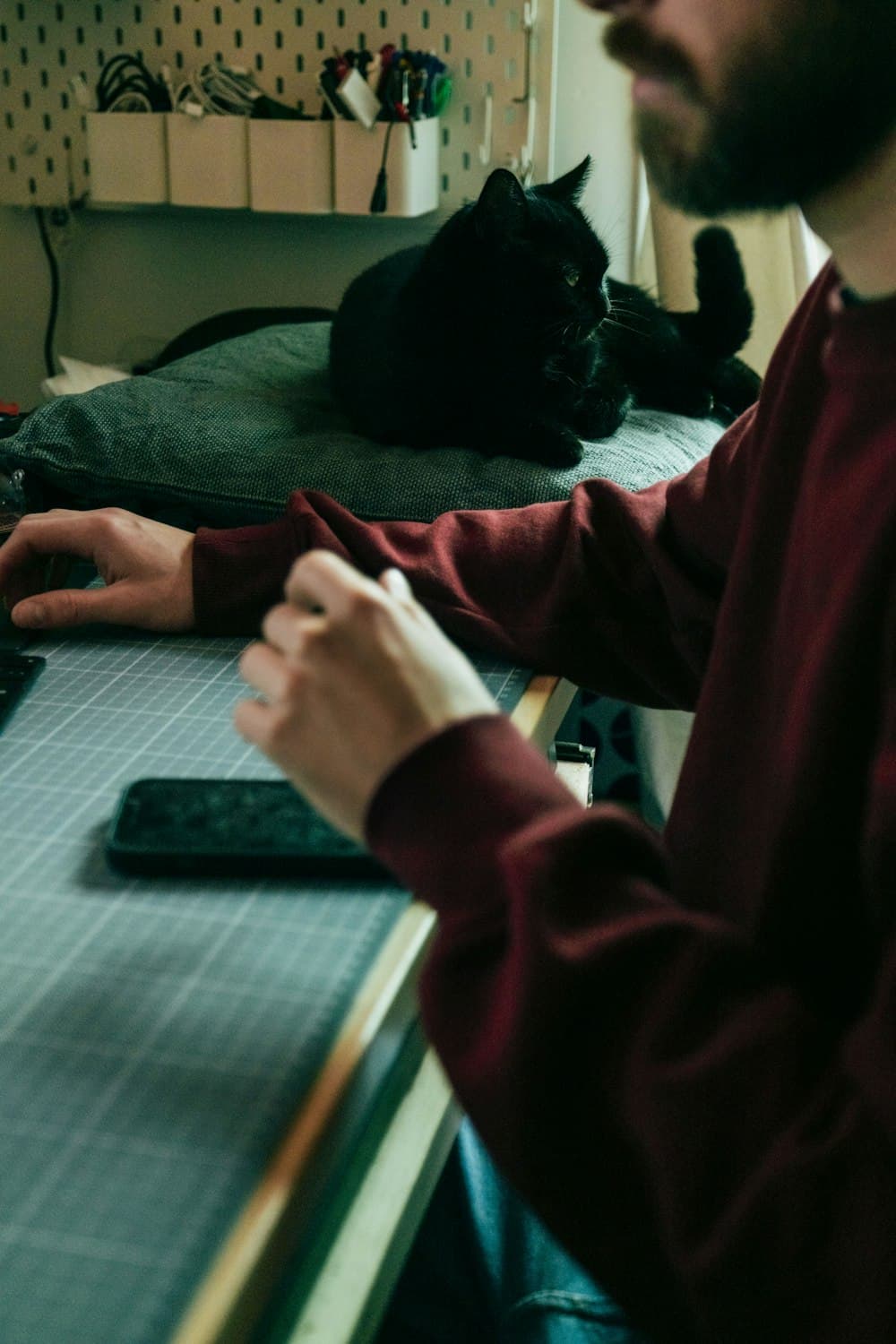 A man deep in work at a desk with a laptop