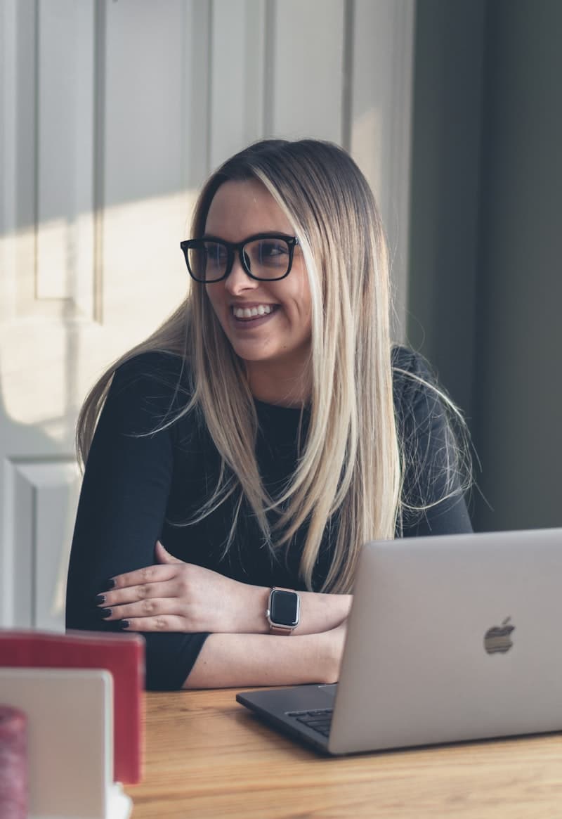 A woman working at a desk with a laptop