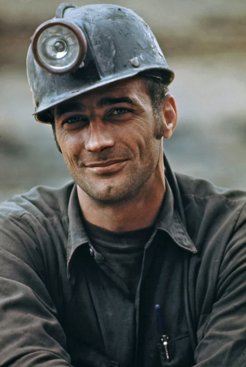 An older builder in a hard hat at a job site