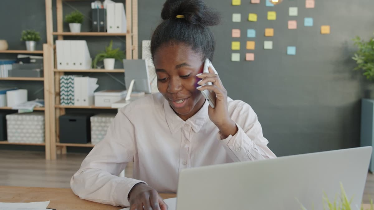 A person pricing a job by phone at an office desk