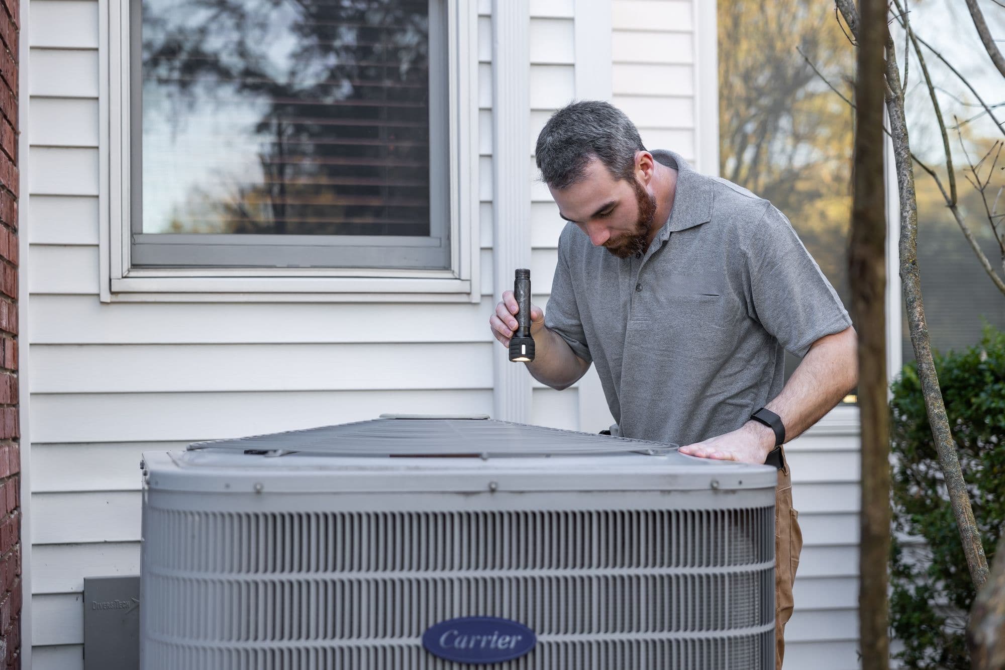 A technician working on rooftop air conditioning units