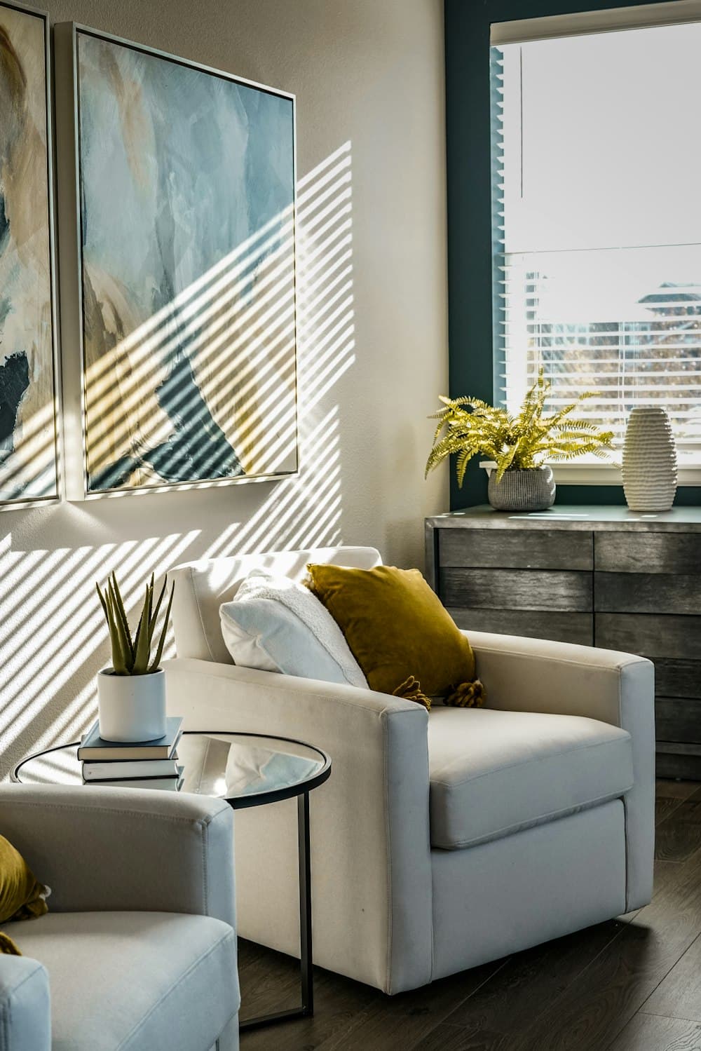 A styled armchair corner with cushions and side table