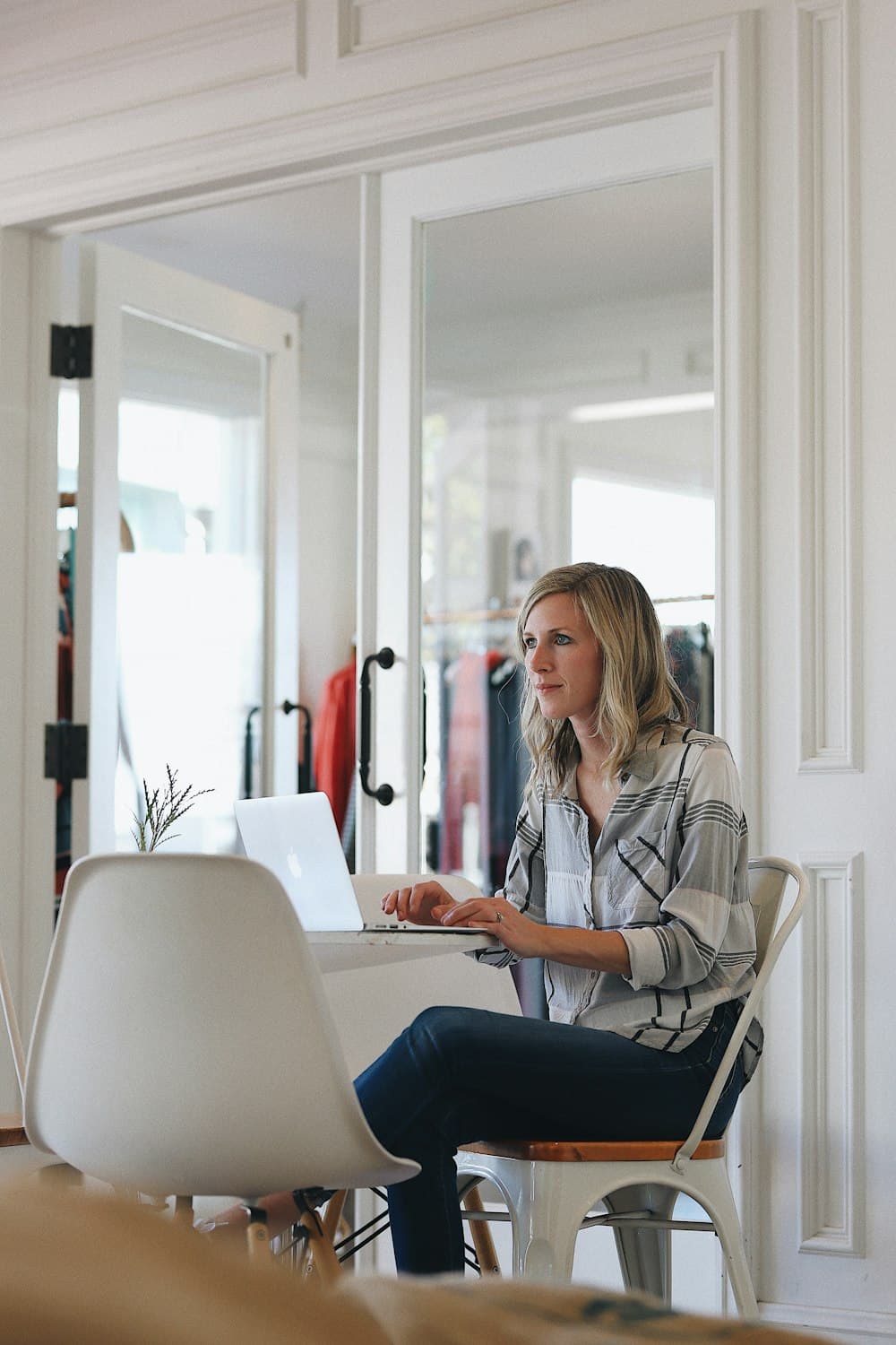 A designer working at a laptop in a bright studio