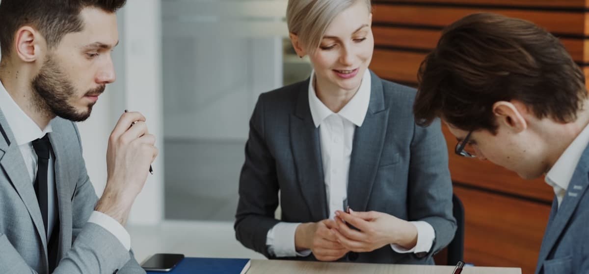 Three attorneys working through a signing at a conference table