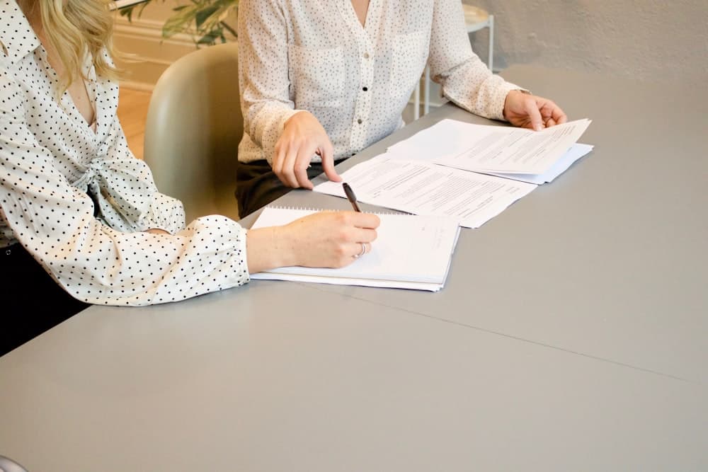 Two people going through documents in a consultation