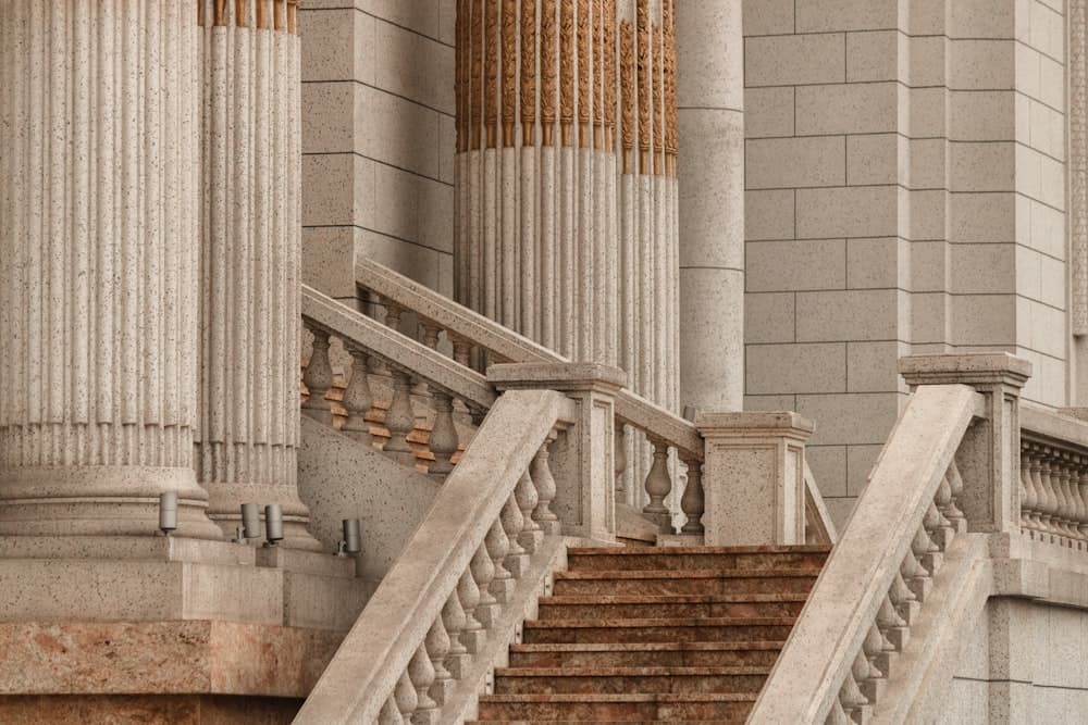 A stone staircase between classical courthouse columns