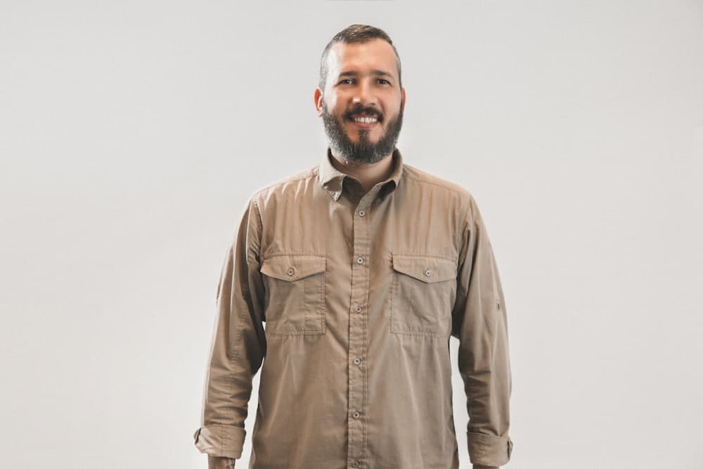 A bearded man in a work shirt facing the camera