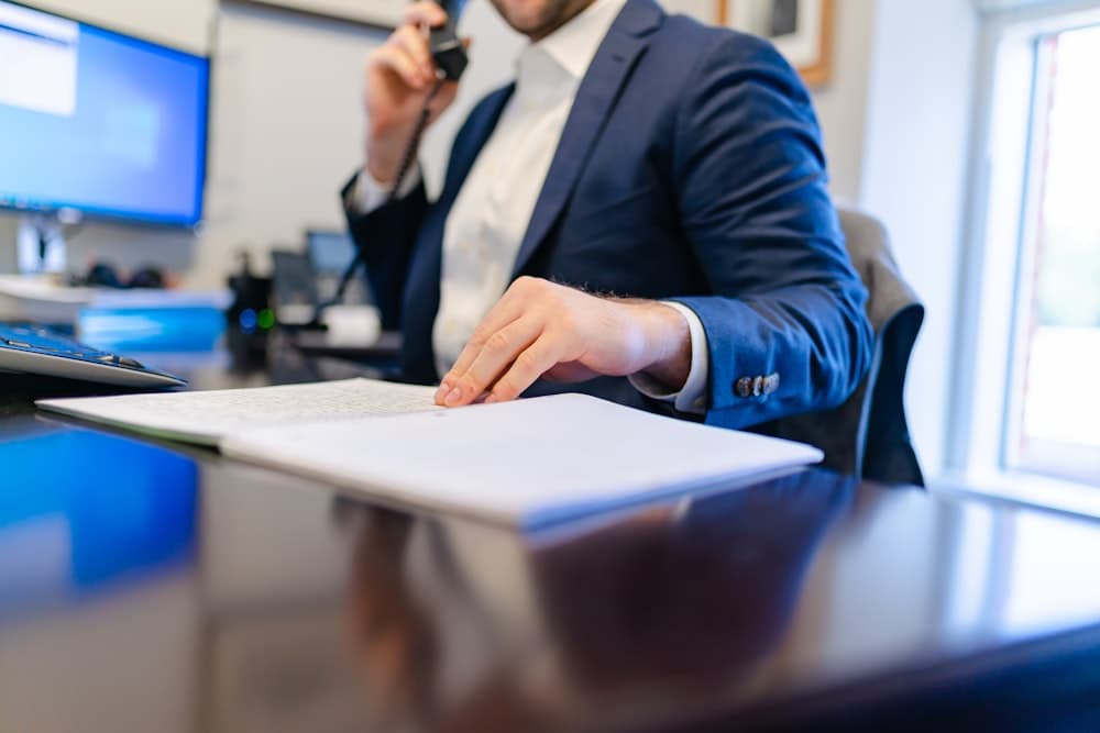 A person pricing a job by phone at an office desk