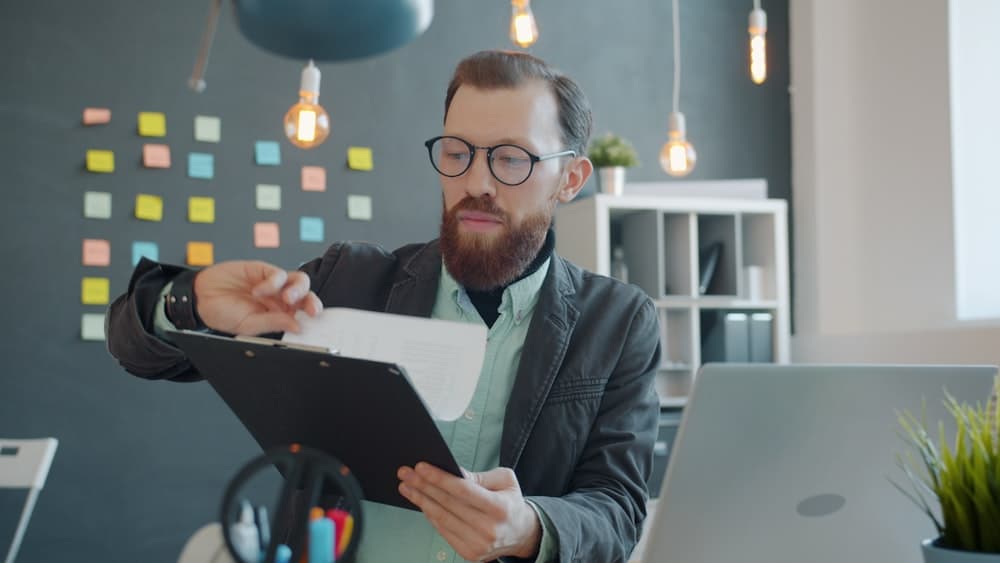 A man reviewing documents at an office desk