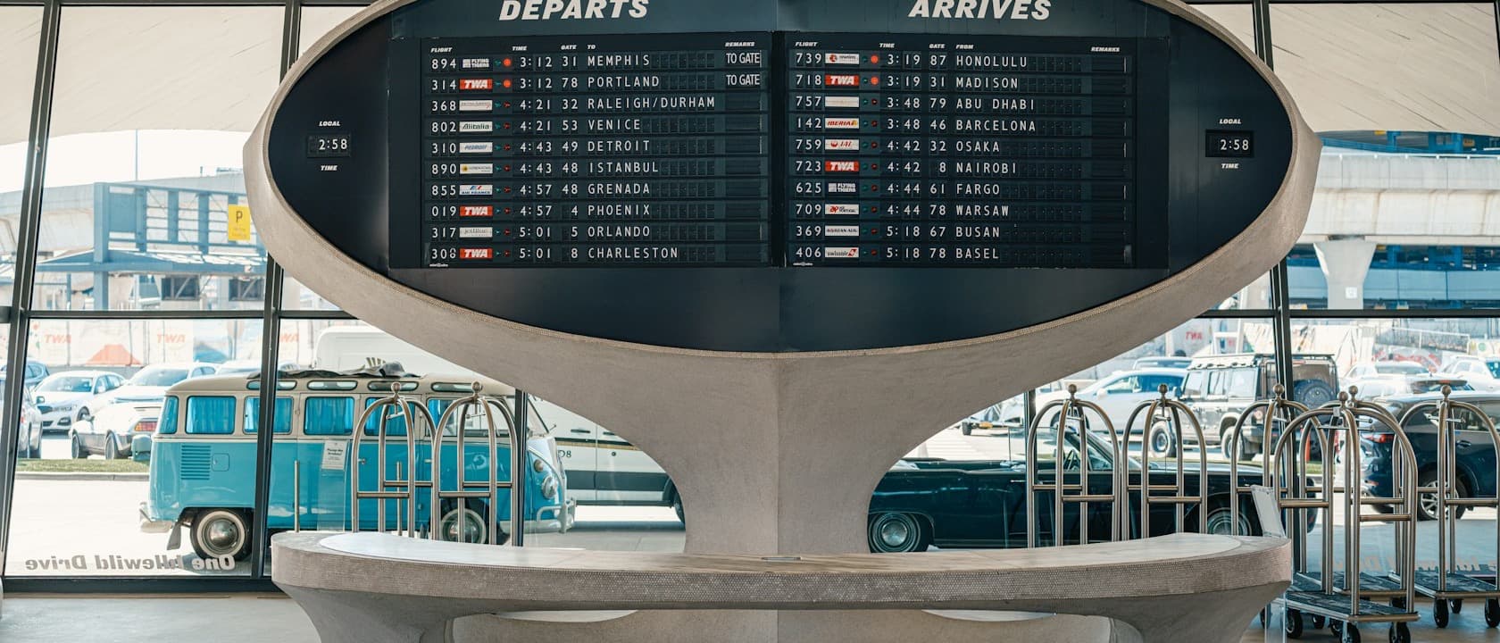 A split-flap departures and arrivals board in an airport hall