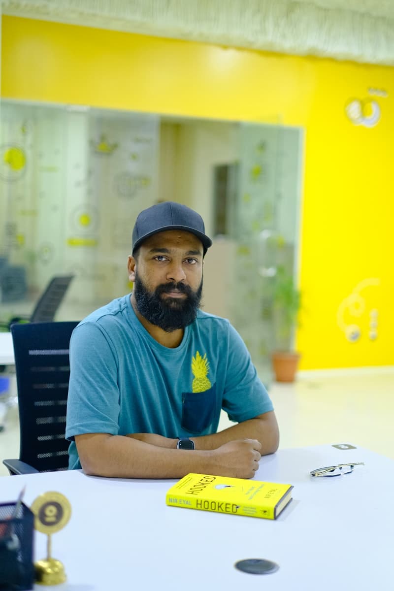 An agency owner seated at a table in his office
