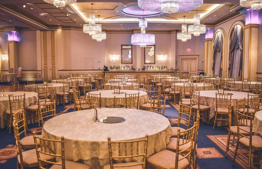 A ballroom set with round tables before an event