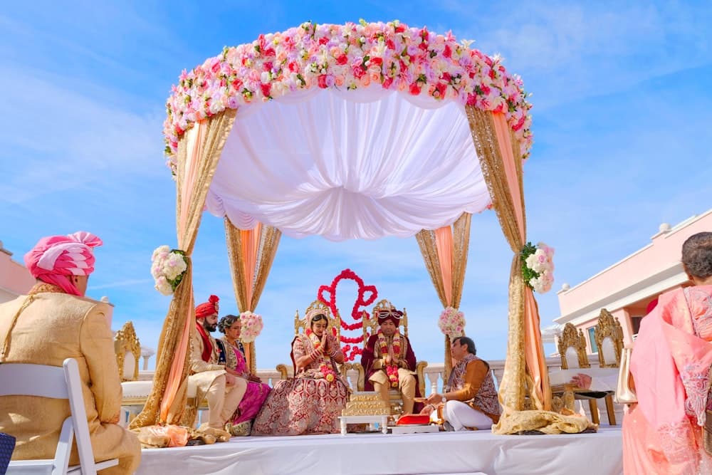 A flower-covered wedding canopy set up outdoors