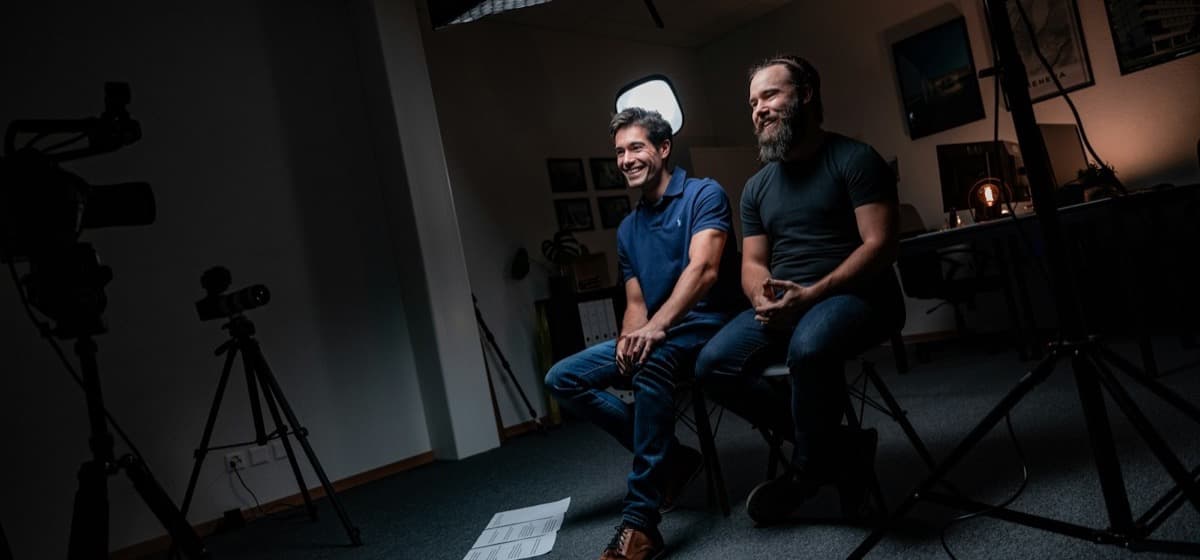 Two filmmakers reviewing an interview setup in their studio