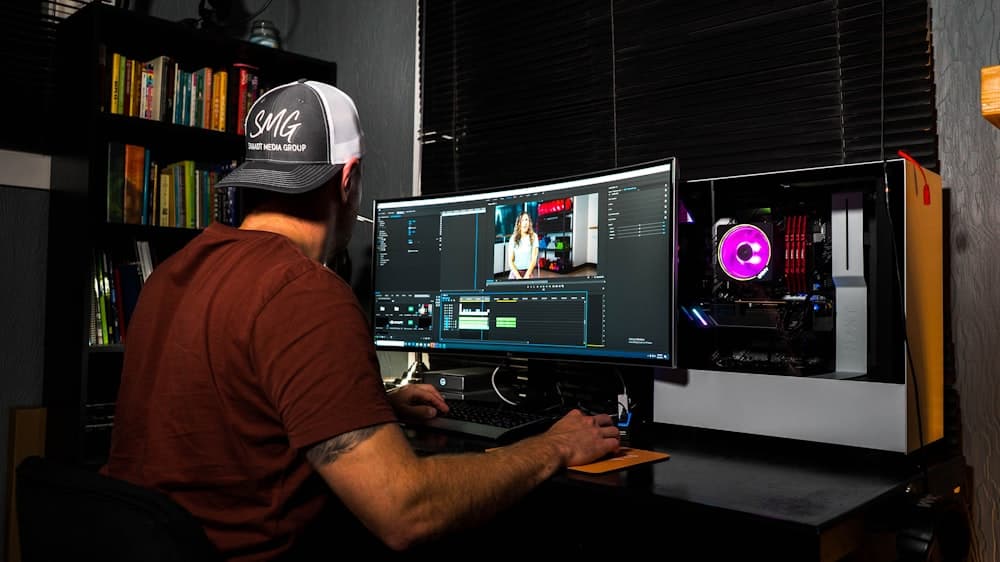 A freelancer color grading at a 2-screen desk setup